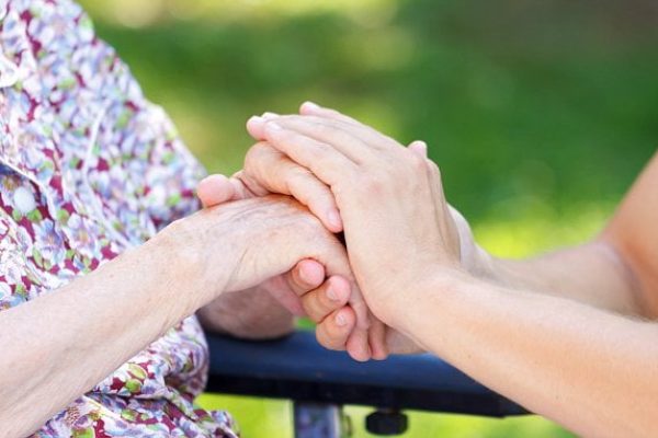Young doctor hand holding an elderly woman's hand; Shutterstock ID 304431182; Purchase Order: -